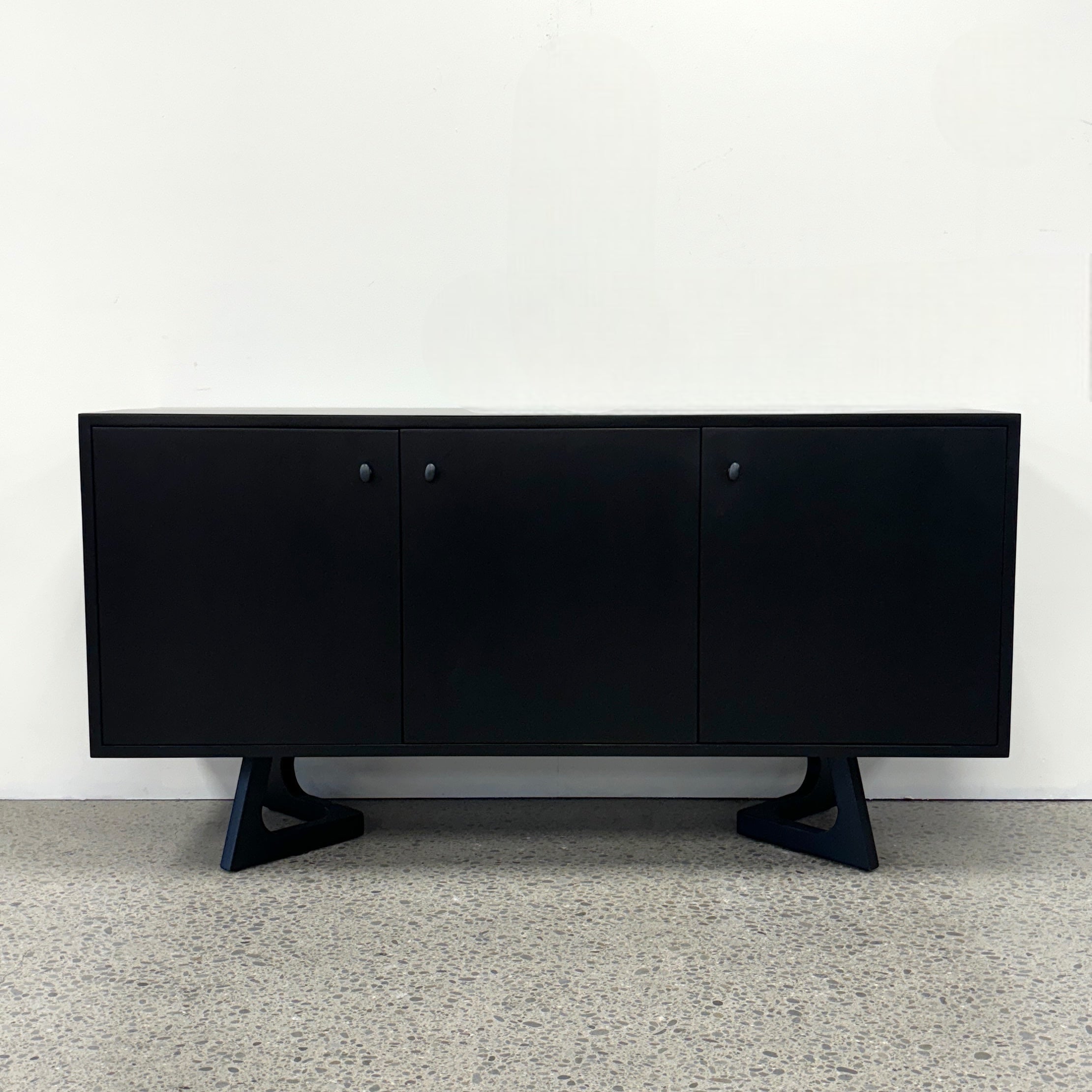 Tex Sideboard front view in black mango wood with subtle iron handles and feature legs