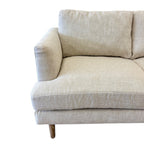 Close-up of the Thomas Sofa's solid timber leg, highlighting the natural timber finish and quality craftsmanship.