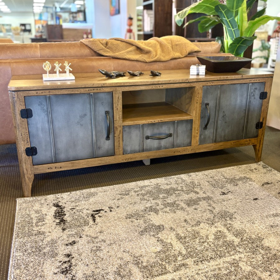 Tinman TV Stand in mango wood and brushed steel displayed in store