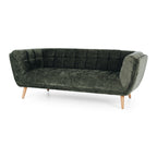 Angled view of the Towelie Sofa in Fern Green, showcasing its channel-tufted design, curved profile and contemporary styling.