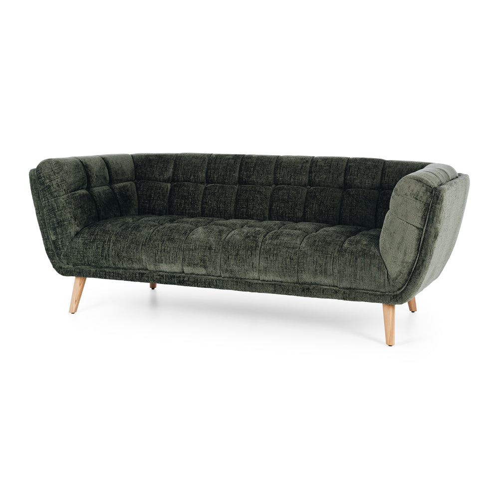 Angled view of the Towelie Sofa in Fern Green, showcasing its channel-tufted design, curved profile and contemporary styling.