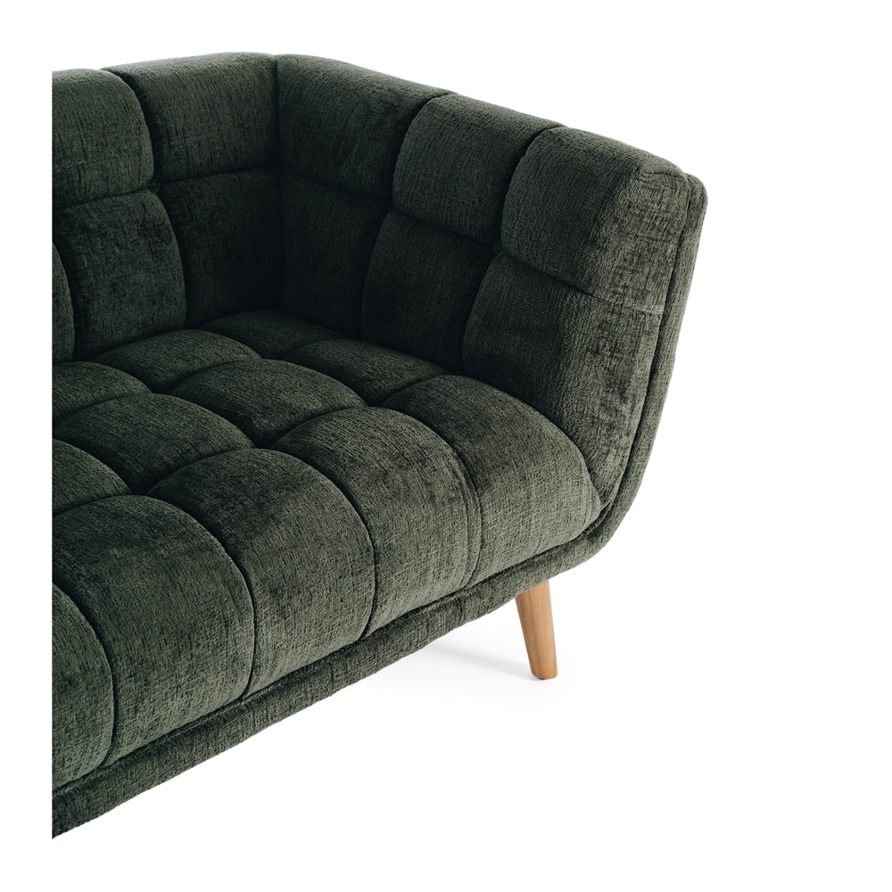 Close-up of the Towelie Sofa's channel-tufted upholstery, highlighting the textured Fern Green fabric and tailored detailing.