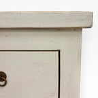 Close-up of the Valtteri Low Console distressed cream painted finish