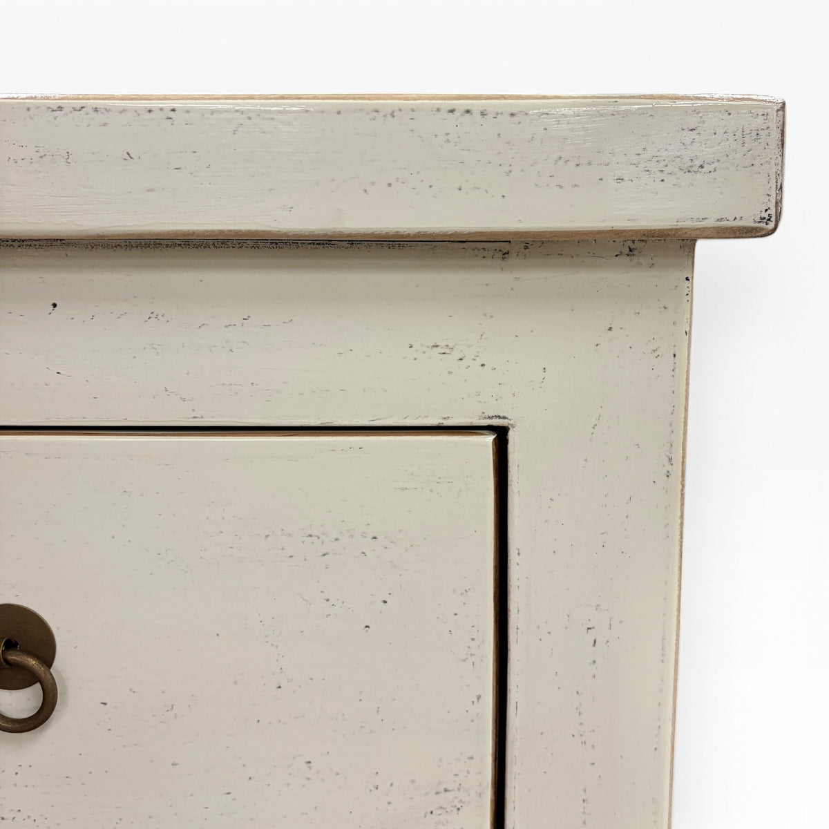 Close-up of the Valtteri Low Console distressed cream painted finish