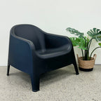 Wainui Outdoor Chair in Black styled with potted greenery