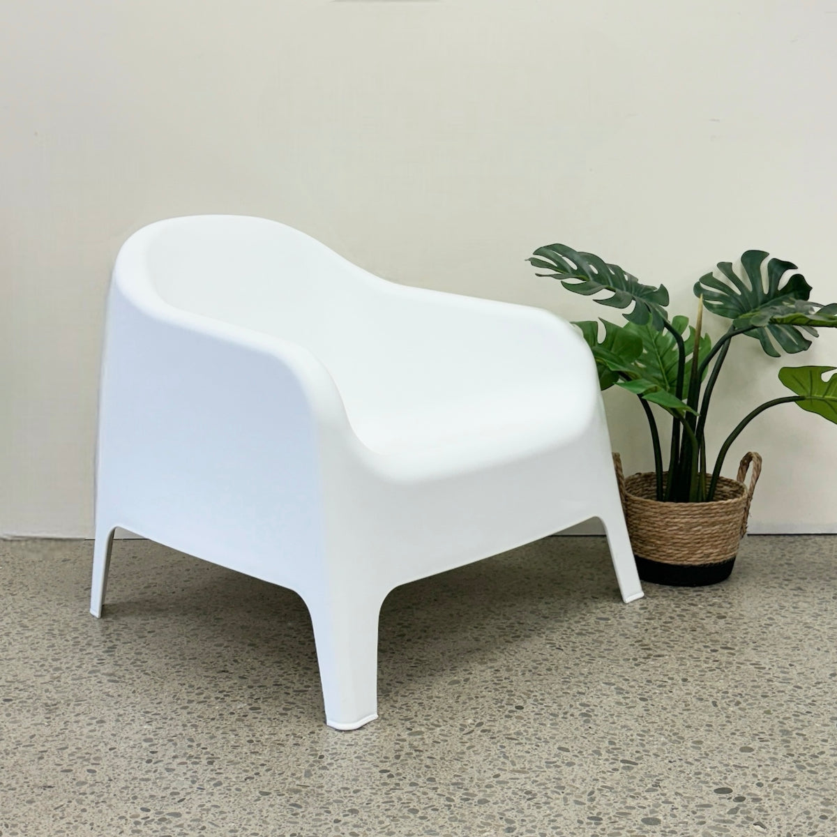 Wainui Outdoor Chair in White styled with potted greenery