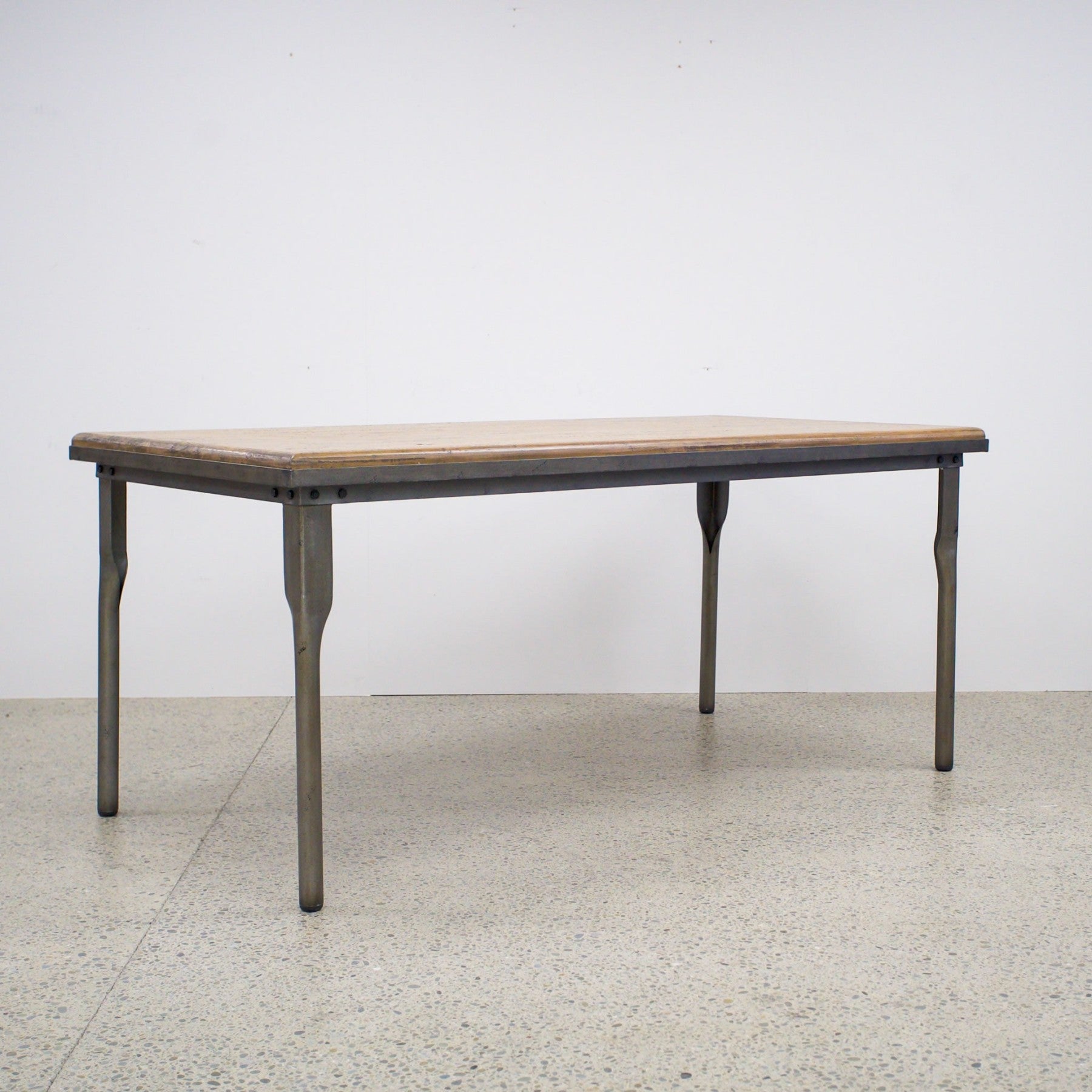 The Workman Dining Table paired with a matching timber bench, creating a relaxed and practical dining setting.
