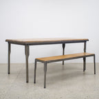 The Workman Dining Table paired with a matching timber bench, creating a relaxed and practical dining setting.