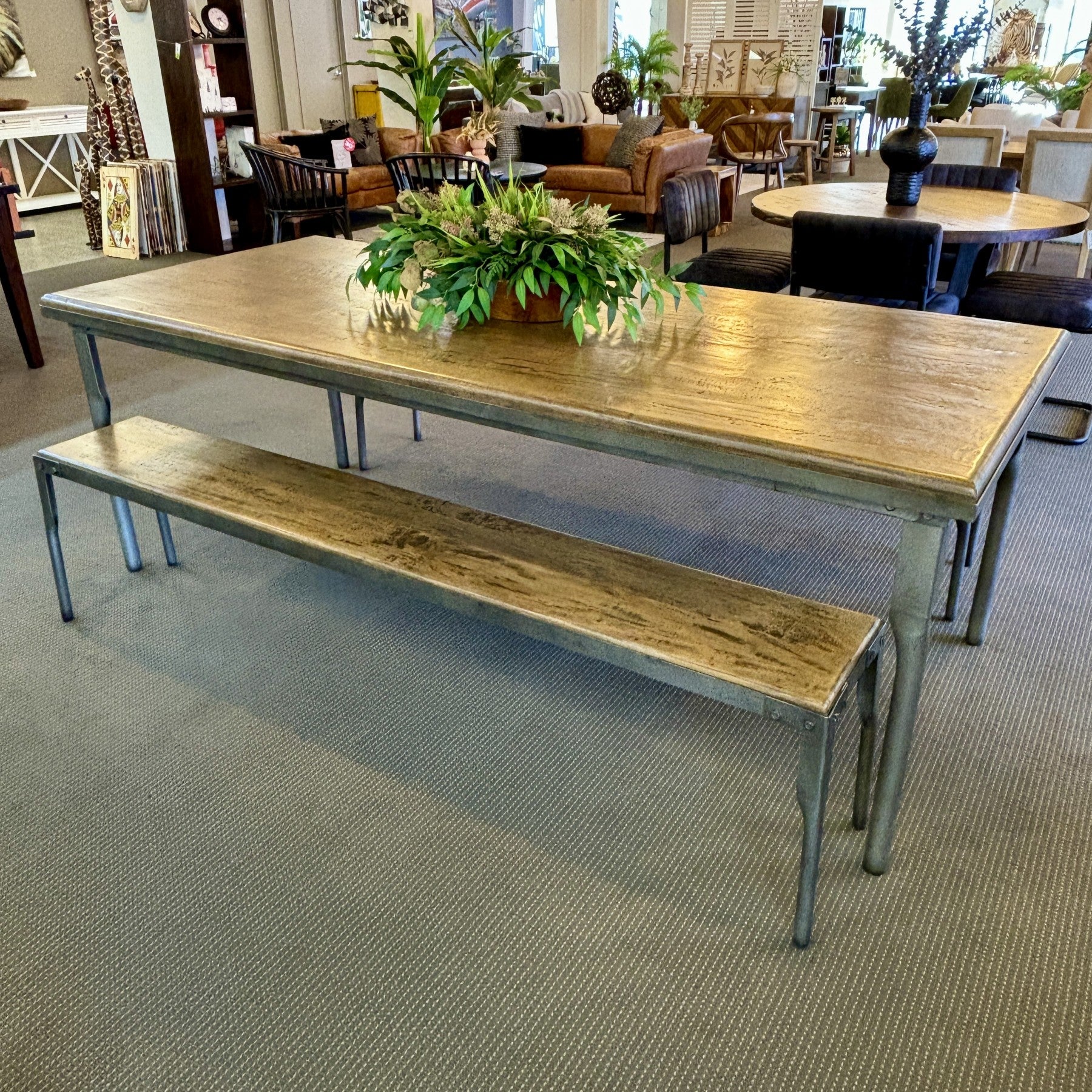 The Workman Dining Table styled in a contemporary dining space, showcasing its generous proportions and solid timber construction.