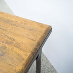 Close-up of the Workman Dining Table's solid timber tabletop, highlighting the natural wood grain and handcrafted finish.